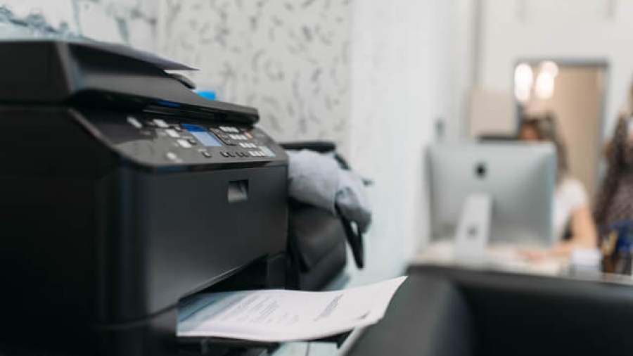 Copier with contract, equipment in business office, Secretary at the workplace on background. Printer on the table in company