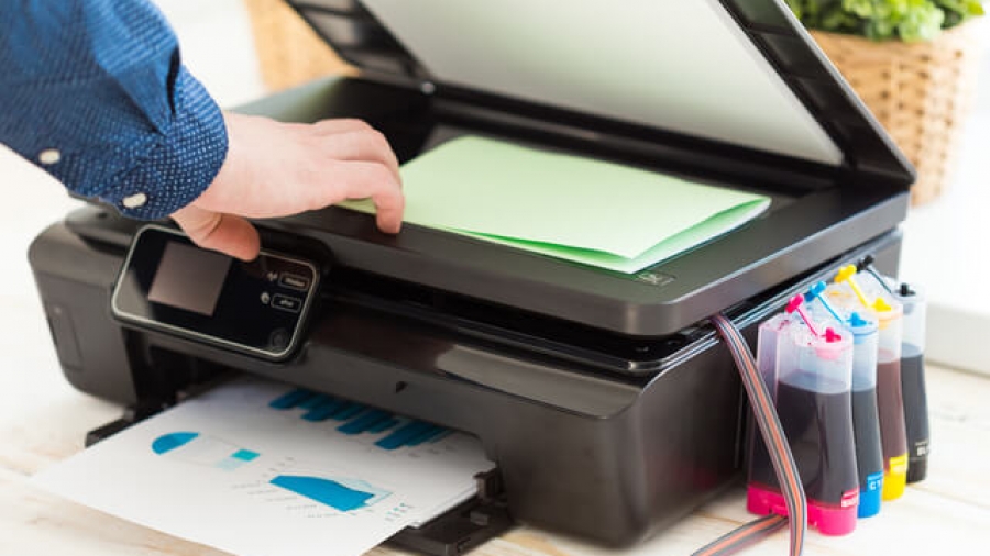 Man's hand making copies. Working with printer